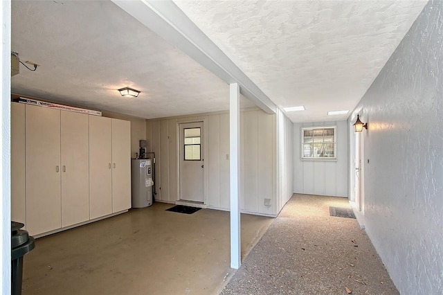 3641 Somerville Dr Unit 1506, Sarasota, FL 34232 - hall featuring electric water heater, a textured ceiling, and a textured wall