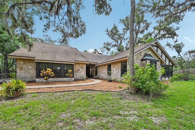 1509 Shadow Ridge Cir, Sarasota, FL 34240 - view of front of home featuring stone siding, a front lawn, and a shingled roof