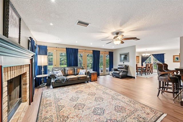 1509 Shadow Ridge Cir, Sarasota, FL 34240 - living room with french doors, light wood-style flooring, a textured ceiling, ceiling fan, and recessed lighting