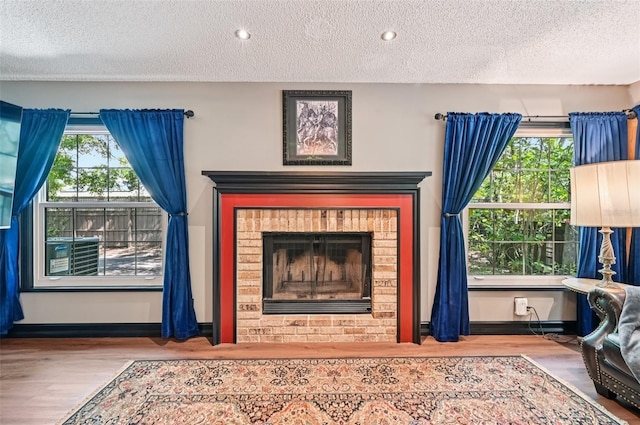 1509 Shadow Ridge Cir, Sarasota, FL 34240 - detailed view of a textured ceiling, wood finished floors, a fireplace, and recessed lighting