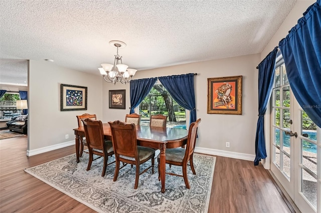 1509 Shadow Ridge Cir, Sarasota, FL 34240 - dining space with a textured ceiling, a chandelier, and wood finished floors