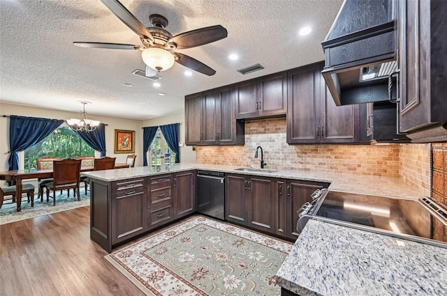 1509 Shadow Ridge Cir, Sarasota, FL 34240 - kitchen with dishwashing machine, a peninsula, a textured ceiling, ventilation hood, and a chandelier
