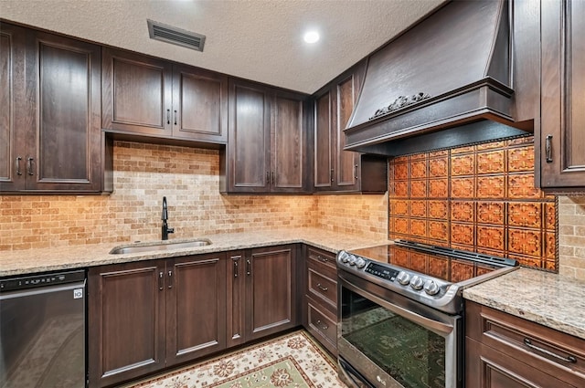 1509 Shadow Ridge Cir, Sarasota, FL 34240 - kitchen featuring stainless steel electric range oven, dishwashing machine, premium range hood, dark brown cabinetry, and a textured ceiling