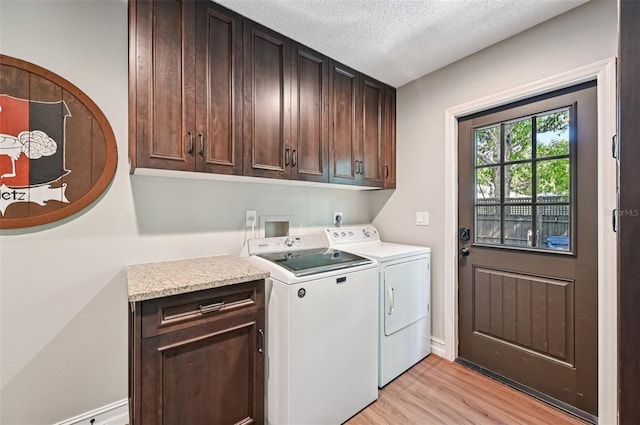 1509 Shadow Ridge Cir, Sarasota, FL 34240 - washroom with cabinet space, light wood-style floors, separate washer and dryer, and a textured ceiling