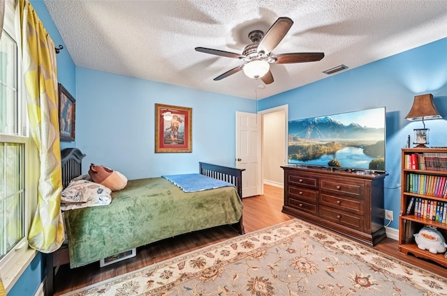 1509 Shadow Ridge Cir, Sarasota, FL 34240 - bedroom with wood finished floors, a textured ceiling, and ceiling fan