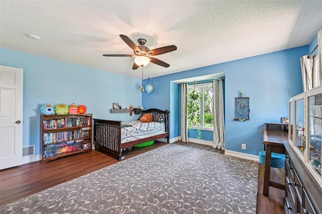 1509 Shadow Ridge Cir, Sarasota, FL 34240 - bedroom featuring wood finished floors, a textured ceiling, and a ceiling fan