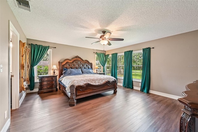 1509 Shadow Ridge Cir, Sarasota, FL 34240 - bedroom with a textured ceiling, wood finished floors, multiple windows, and a ceiling fan