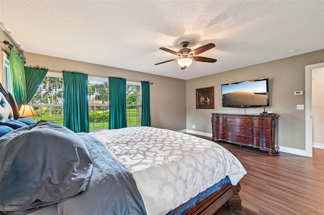 1509 Shadow Ridge Cir, Sarasota, FL 34240 - bedroom featuring wood finished floors, a textured ceiling, multiple windows, and a ceiling fan