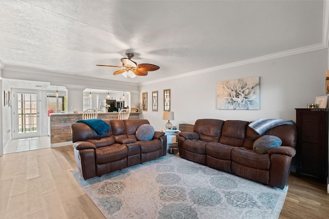 2415 Bayshore Gardens Pkwy Unit 2, Bradenton, FL 34207 - living area with light wood finished floors, ornamental molding, ceiling fan, and ornate columns