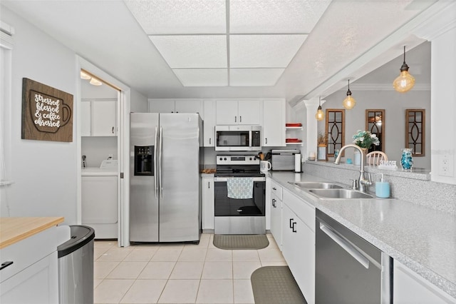 2415 Bayshore Gardens Pkwy Unit 2, Bradenton, FL 34207 - kitchen with stainless steel appliances, washer / clothes dryer, light countertops, light tile patterned flooring, and white cabinets