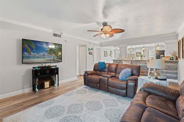 2415 Bayshore Gardens Pkwy Unit 2, Bradenton, FL 34207 - living area featuring wood finished floors, a ceiling fan, crown molding, and decorative columns