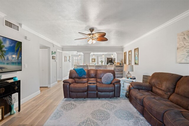 2415 Bayshore Gardens Pkwy Unit 2, Bradenton, FL 34207 - living area with light wood-style floors, a ceiling fan, ornamental molding, and ornate columns