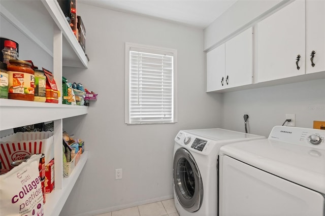 2415 Bayshore Gardens Pkwy Unit 2, Bradenton, FL 34207 - laundry area with washing machine and dryer, cabinet space, and light tile patterned floors