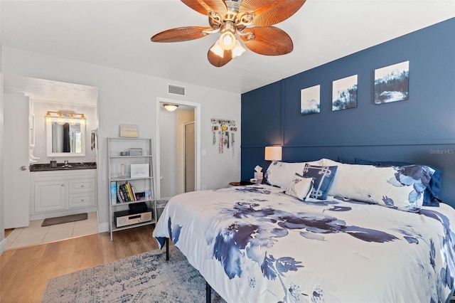 2415 Bayshore Gardens Pkwy Unit 2, Bradenton, FL 34207 - bedroom with light wood-type flooring, ensuite bathroom, and ceiling fan
