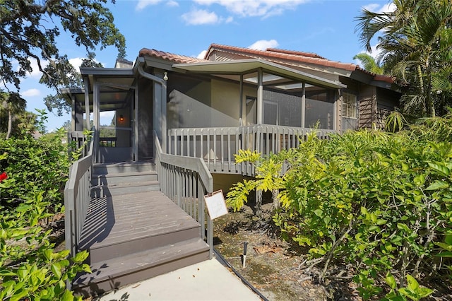4333 Trails Dr Unit 10-1, Sarasota, FL 34232 - view of property exterior featuring a sunroom and a tile roof