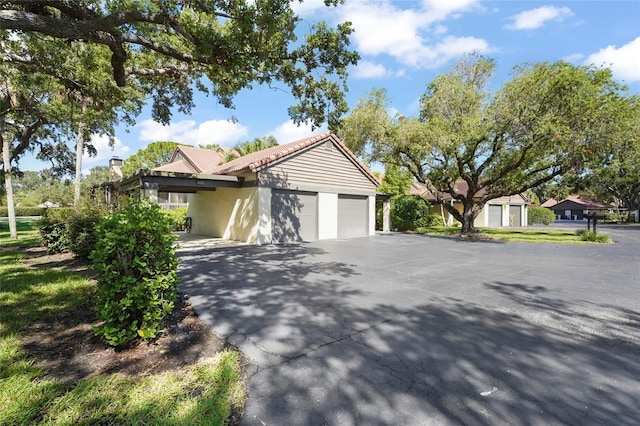 4333 Trails Dr Unit 10-1, Sarasota, FL 34232 - single story home featuring stucco siding, an attached garage, driveway, and a tiled roof