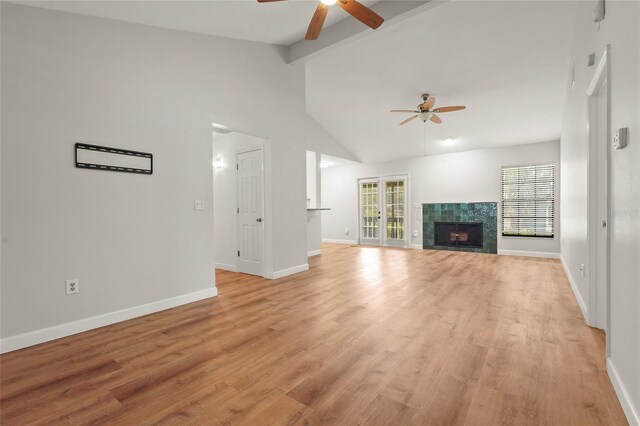 4333 Trails Dr Unit 10-1, Sarasota, FL 34232 - unfurnished living room featuring ceiling fan, light wood-style floors, and a tile fireplace