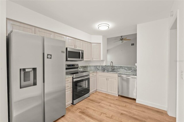 4333 Trails Dr Unit 10-1, Sarasota, FL 34232 - kitchen with stainless steel appliances, light wood-type flooring, a ceiling fan, and light stone countertops