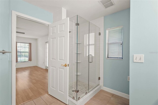 4333 Trails Dr Unit 10-1, Sarasota, FL 34232 - bathroom featuring a stall shower and wood finished floors