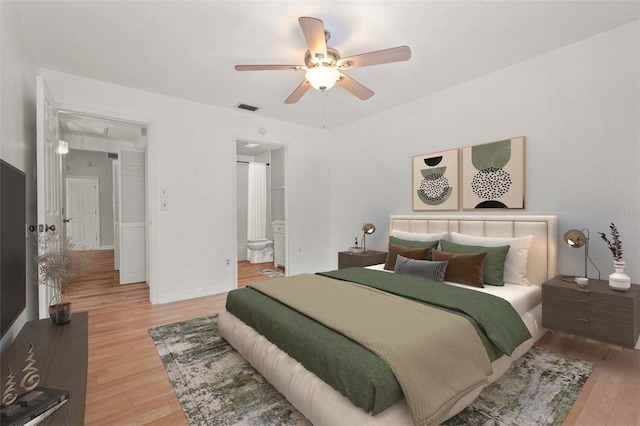 4333 Trails Dr Unit 10-1, Sarasota, FL 34232 - bedroom featuring light wood-style floors, attic access, a ceiling fan, and connected bathroom
