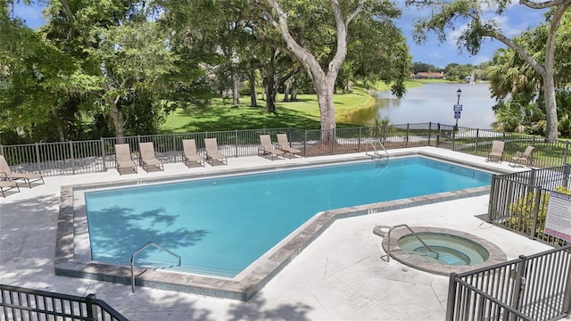 4333 Trails Dr Unit 10-1, Sarasota, FL 34232 - community pool with a community hot tub, a water view, a patio, and view of wooded area