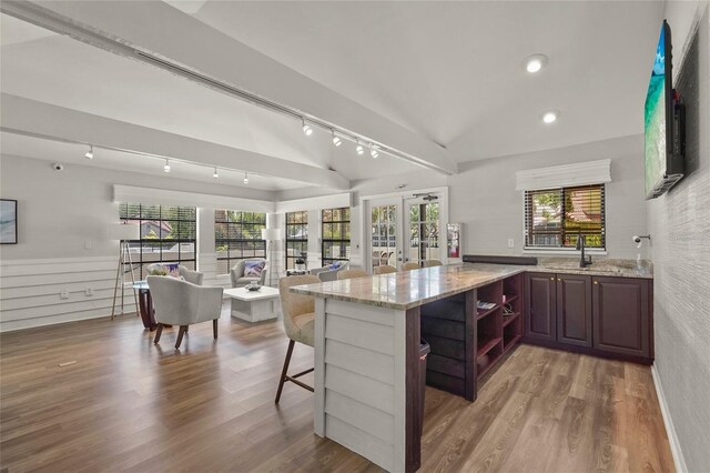 4333 Trails Dr Unit 10-1, Sarasota, FL 34232 - kitchen featuring rail lighting, a kitchen breakfast bar, open shelves, light stone counters, and recessed lighting