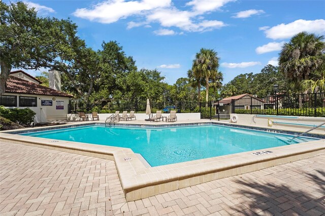 4333 Trails Dr Unit 10-1, Sarasota, FL 34232 - community pool featuring a patio area and view of wooded area