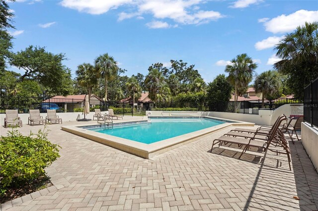 4333 Trails Dr Unit 10-1, Sarasota, FL 34232 - community pool featuring a patio area