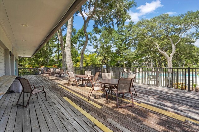 4333 Trails Dr Unit 10-1, Sarasota, FL 34232 - wooden deck with outdoor dining space and a community pool