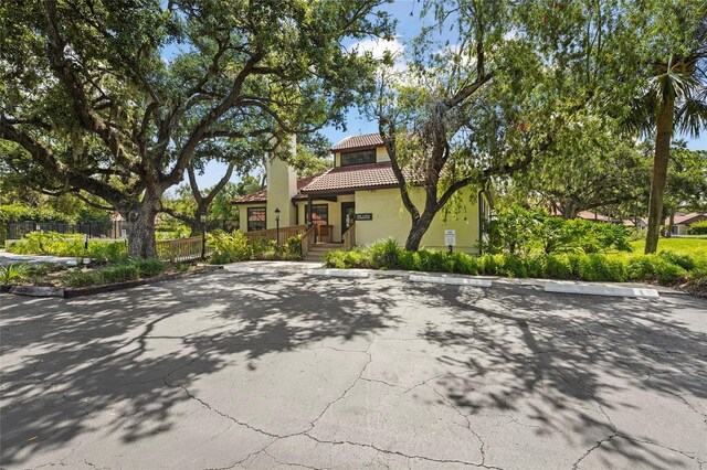 4333 Trails Dr Unit 10-1, Sarasota, FL 34232 - view of front facade featuring a tile roof, stucco siding, and uncovered parking