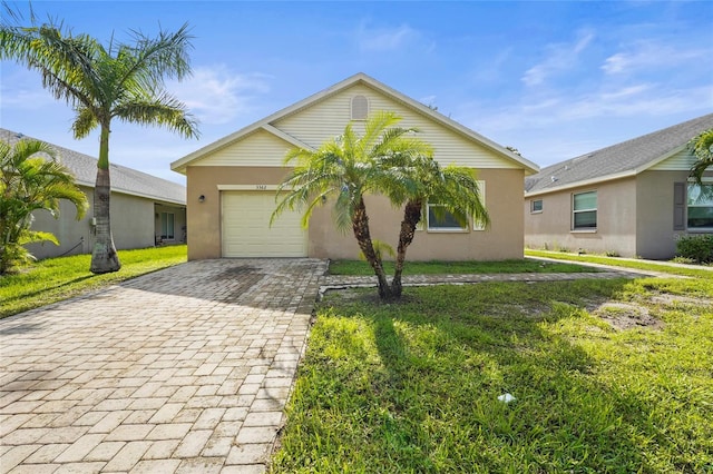 3362 Howell Pl, Sarasota, FL 34232 - view of front of house with decorative driveway, a garage, stucco siding, and a front lawn