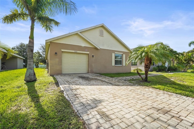 3362 Howell Pl, Sarasota, FL 34232 - view of front facade with stucco siding, decorative driveway, a front lawn, and an attached garage