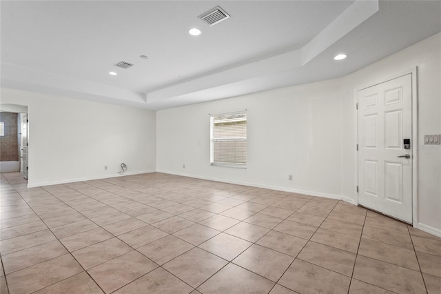 3362 Howell Pl, Sarasota, FL 34232 - spare room with a tray ceiling, light tile patterned flooring, and recessed lighting