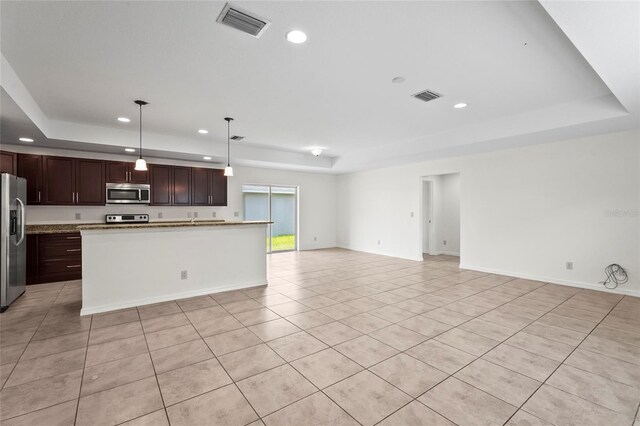 3362 Howell Pl, Sarasota, FL 34232 - kitchen featuring stainless steel appliances, a tray ceiling, open floor plan, recessed lighting, and light tile patterned flooring