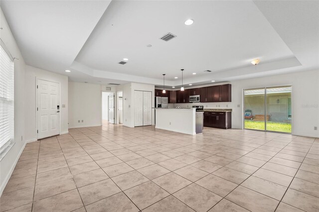 3362 Howell Pl, Sarasota, FL 34232 - unfurnished living room with a raised ceiling, recessed lighting, and light tile patterned flooring