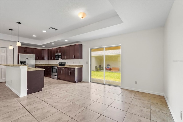 3362 Howell Pl, Sarasota, FL 34232 - kitchen with appliances with stainless steel finishes, a raised ceiling, light tile patterned floors, recessed lighting, and pendant lighting