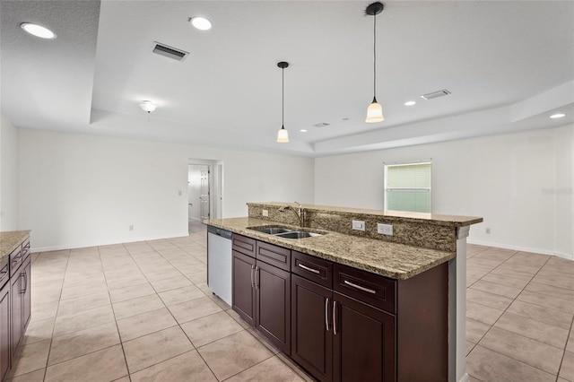 3362 Howell Pl, Sarasota, FL 34232 - kitchen with a tray ceiling, stainless steel dishwasher, light tile patterned floors, decorative light fixtures, and recessed lighting