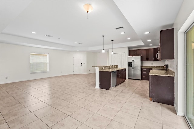 3362 Howell Pl, Sarasota, FL 34232 - kitchen featuring appliances with stainless steel finishes, a tray ceiling, open floor plan, recessed lighting, and dark brown cabinetry