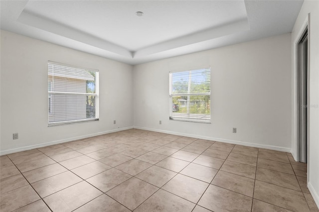 3362 Howell Pl, Sarasota, FL 34232 - spare room featuring a raised ceiling and light tile patterned floors