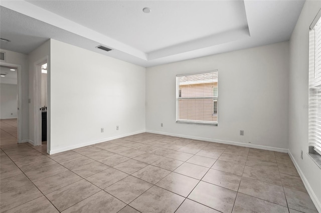 3362 Howell Pl, Sarasota, FL 34232 - empty room with tile patterned floors and a raised ceiling
