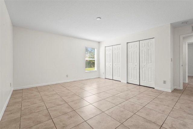 3362 Howell Pl, Sarasota, FL 34232 - unfurnished bedroom with two closets and light tile patterned floors