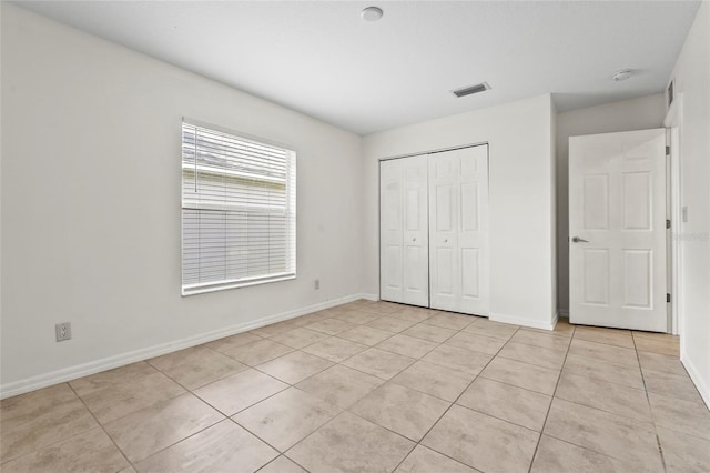 3362 Howell Pl, Sarasota, FL 34232 - unfurnished bedroom featuring light tile patterned floors and a closet