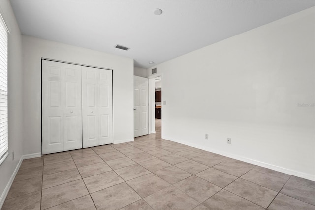 3362 Howell Pl, Sarasota, FL 34232 - unfurnished bedroom featuring light tile patterned floors and a closet