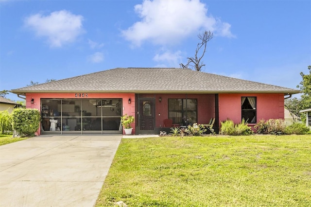 4145 W Price Blvd, North Port, FL 34286 - view of front of house featuring driveway, a front lawn, an attached garage, and stucco siding