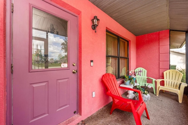 4145 W Price Blvd, North Port, FL 34286 - doorway to property featuring stucco siding and covered porch