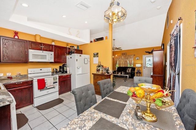 4145 W Price Blvd, North Port, FL 34286 - kitchen featuring white appliances, light tile patterned floors, reddish brown cabinets, open floor plan, and light countertops