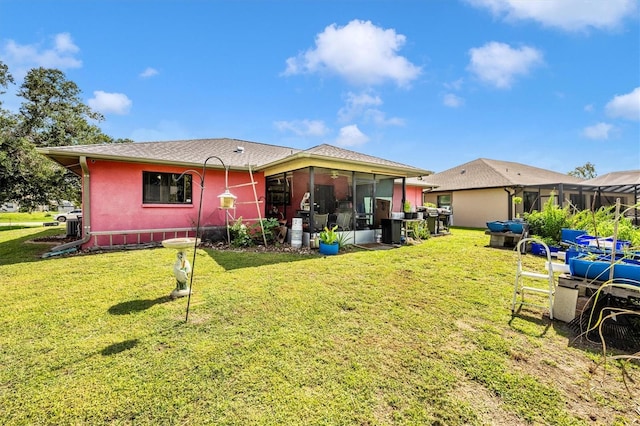 4145 W Price Blvd, North Port, FL 34286 - back of house featuring a sunroom and a lawn