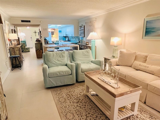 555 The Esplanade N Unit 202, Venice, FL 34285 - living area featuring ornamental molding and a textured ceiling