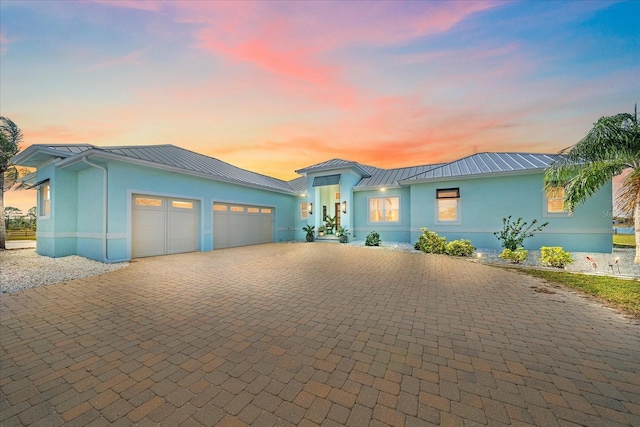 29527 Leah Rd, Punta Gorda, FL 33982 - view of front of property featuring a standing seam roof, decorative driveway, a metal roof, and stucco siding