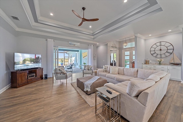 29527 Leah Rd, Punta Gorda, FL 33982 - living room featuring a raised ceiling, ceiling fan, wood finished floors, ornamental molding, and recessed lighting